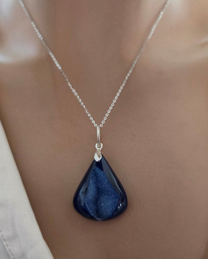 Necklace with a blue teardrop pendant on a mannequin