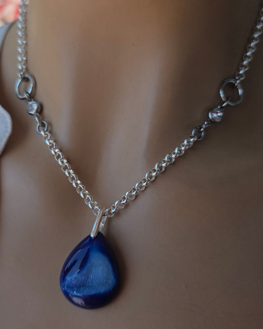 Mannequin wearing a necklace with a blue pendant