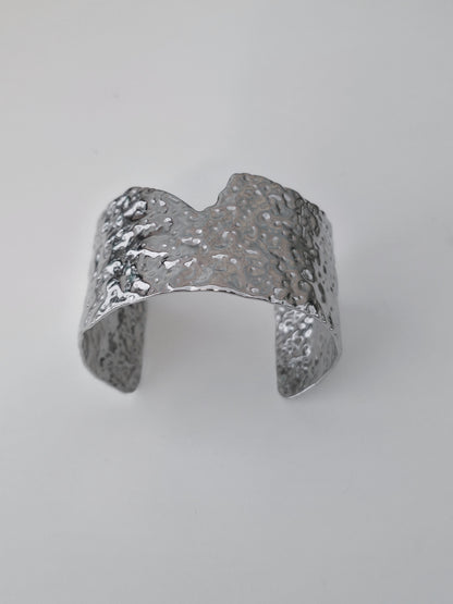 Silver textured ring on a light gray background