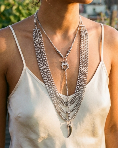 Woman wearing layered necklaces with a cityscape in the background