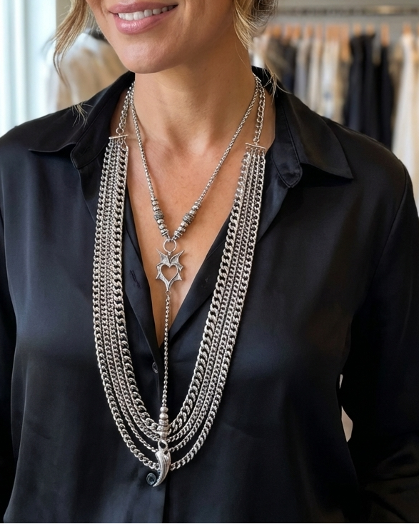 Woman wearing a black shirt and layered necklaces in a store setting