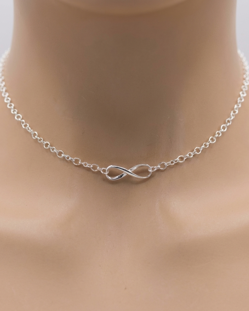Silver infinity necklace on a mannequin neck