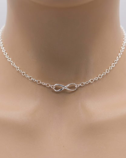 Silver infinity necklace on a mannequin neck