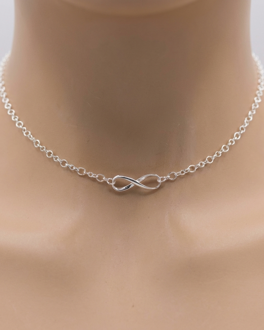 Silver infinity necklace on a mannequin neck