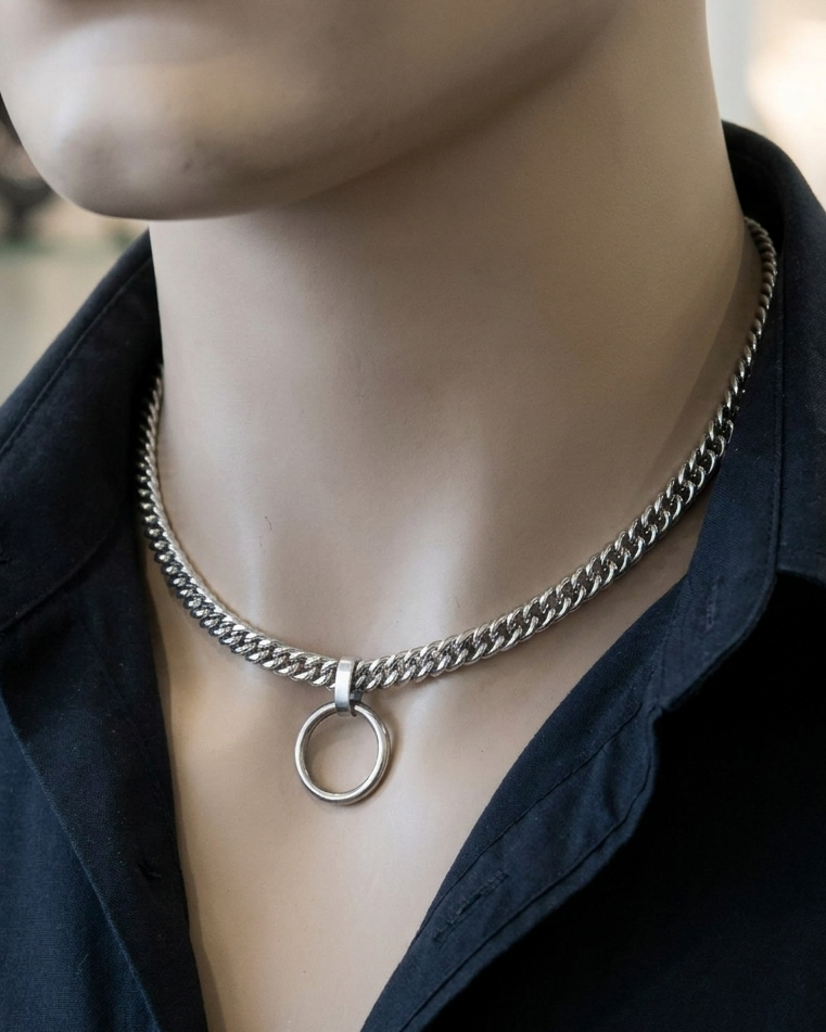 Mannequin wearing a black shirt with a silver chain necklace featuring a circular pendant.