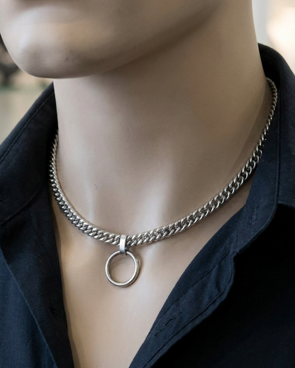 Mannequin wearing a black shirt with a silver chain necklace featuring a circular pendant.
