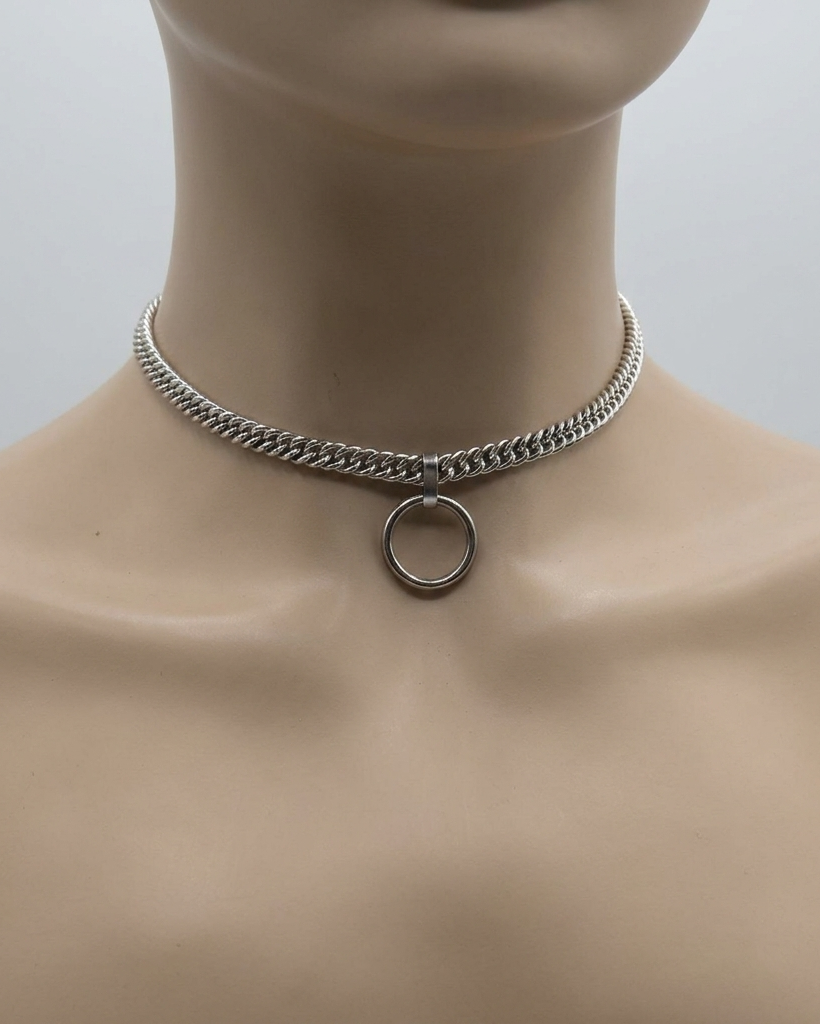 Silver chain choker necklace on a mannequin neck with a plain background