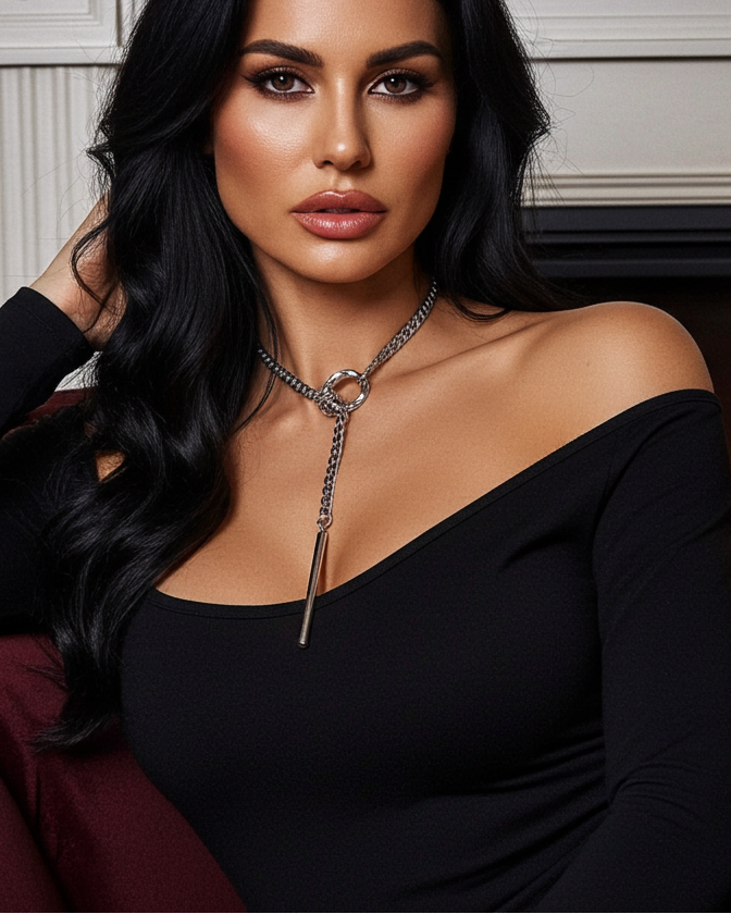 Woman in a black dress sitting in front of a fireplace