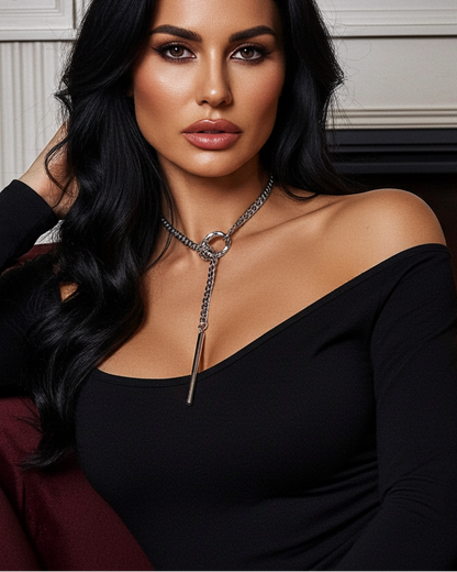 Woman in a black dress sitting in front of a fireplace