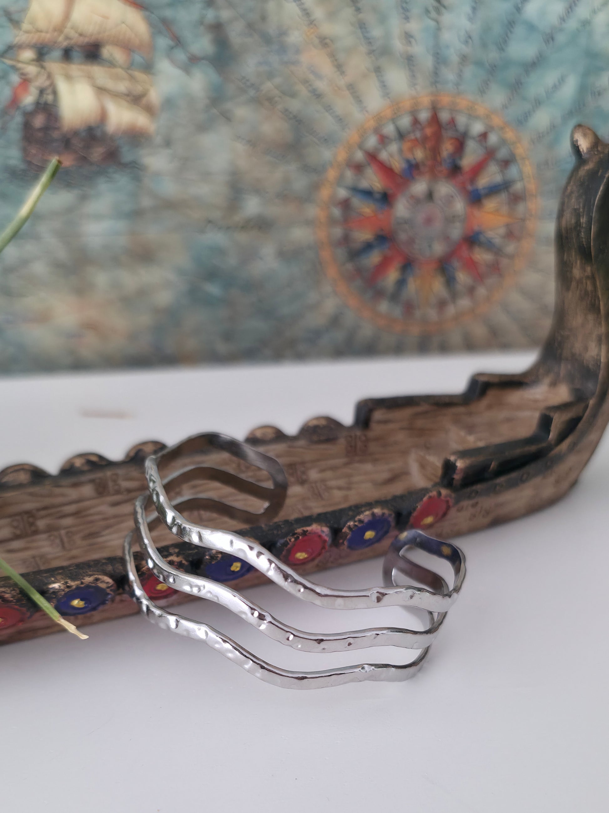 Silver earrings with colorful stones on a decorative background
