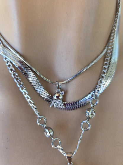 Photo of a genuine ocean-tumbled sea glass pendant in stainless steel bezel on a stainless steel chain, handmade coastal jewelry inspired by Norse goddess style.